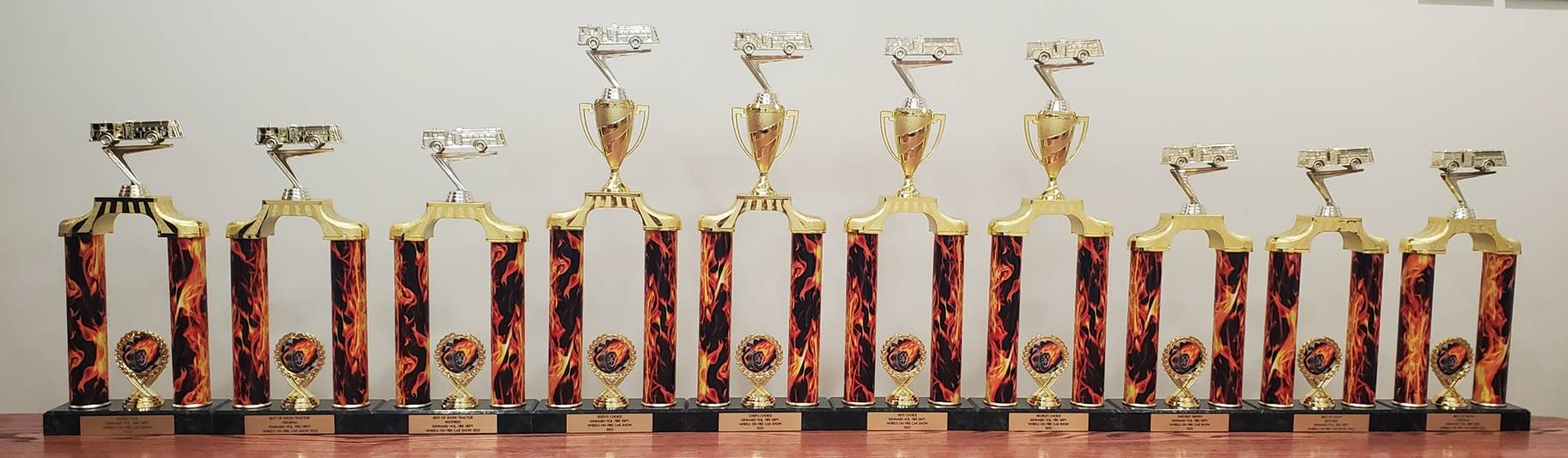 A row of trophies on a table
Description automatically generated